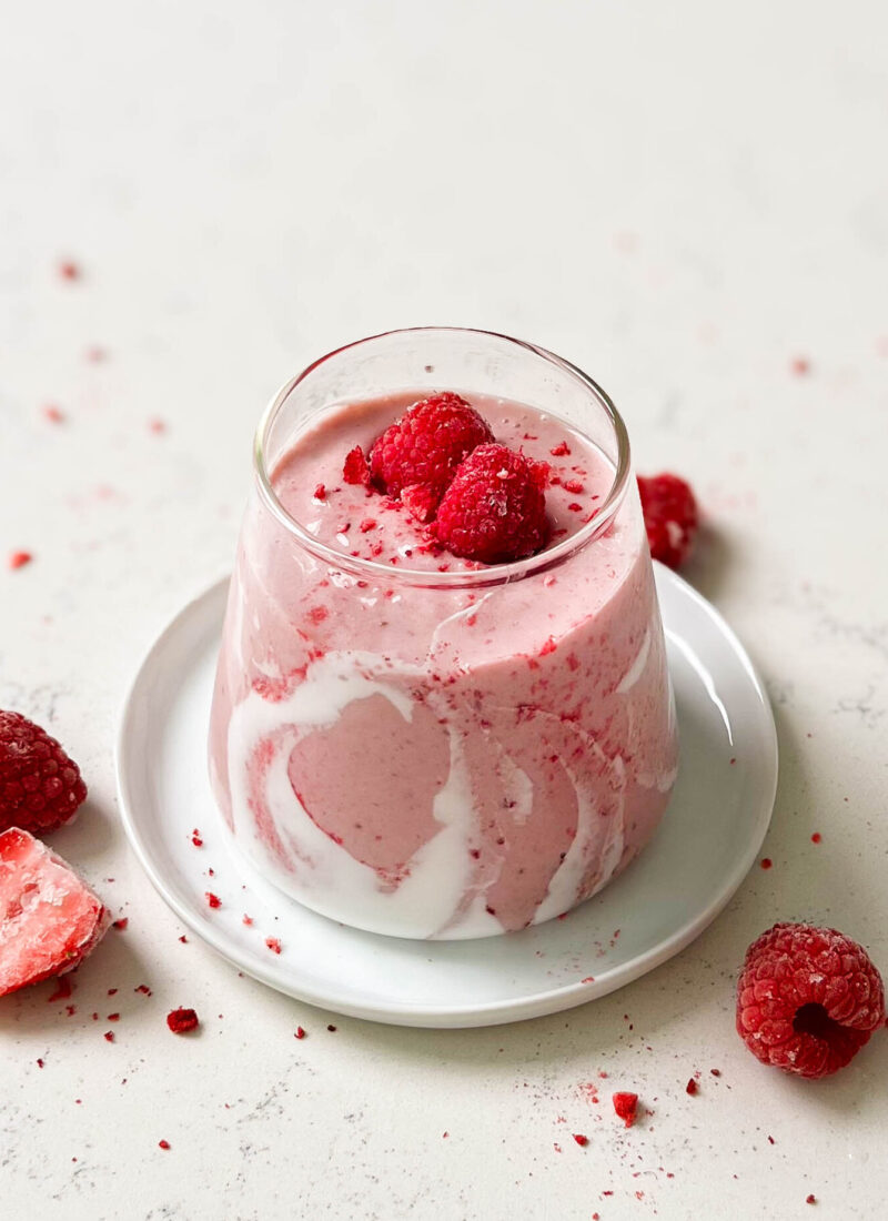strawberry coconut cloud smoothie in a triangle glass