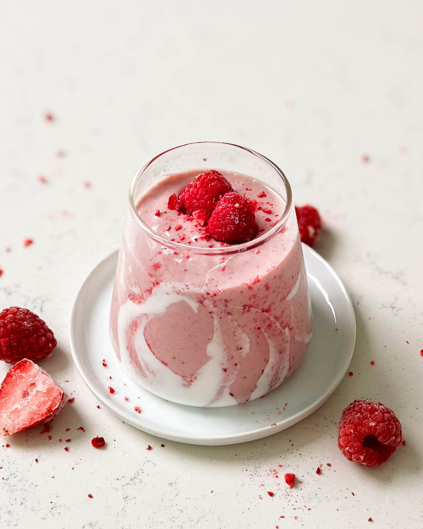 strawberry coconut cloud smoothie in a triangle glass