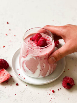 strawberry coconut cloud smoothie in a triangle glass