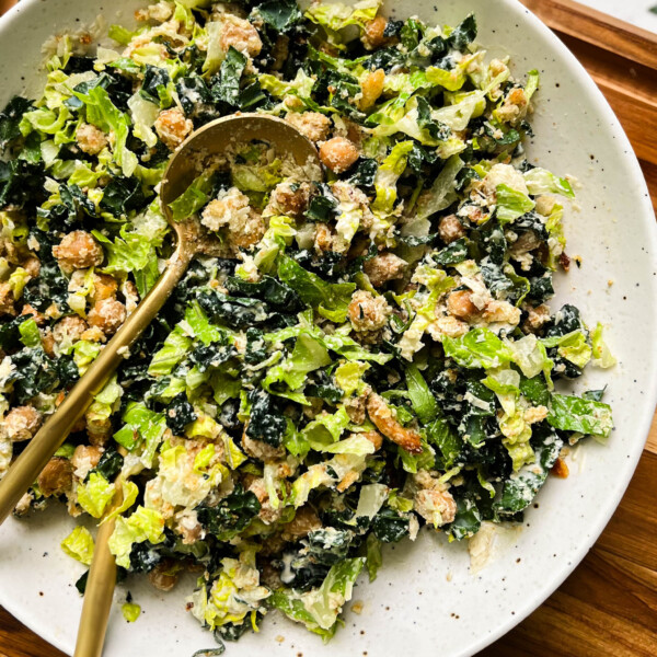 vegan kale caesar salad in a white bowl