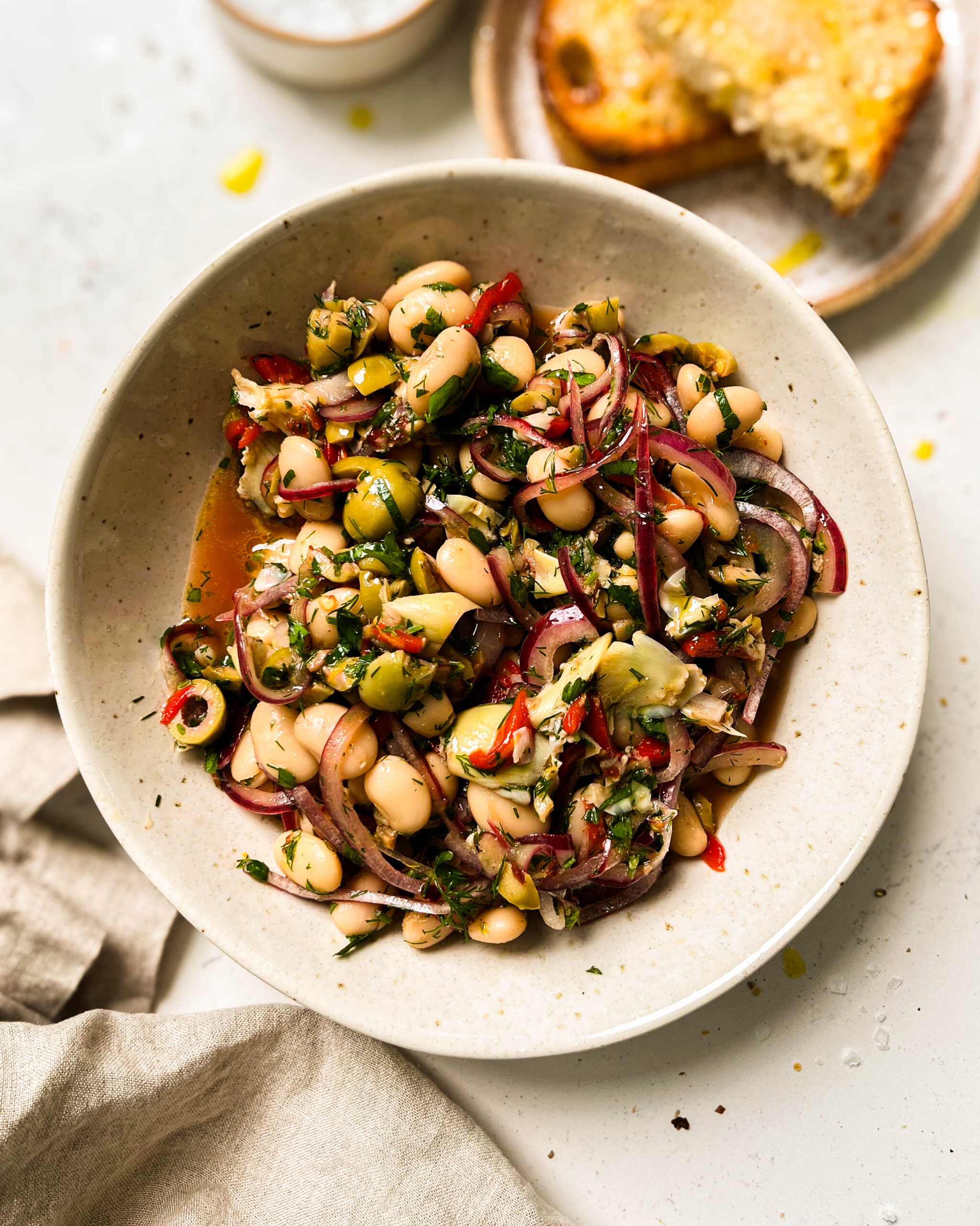 marinated butter beans in a white bowl