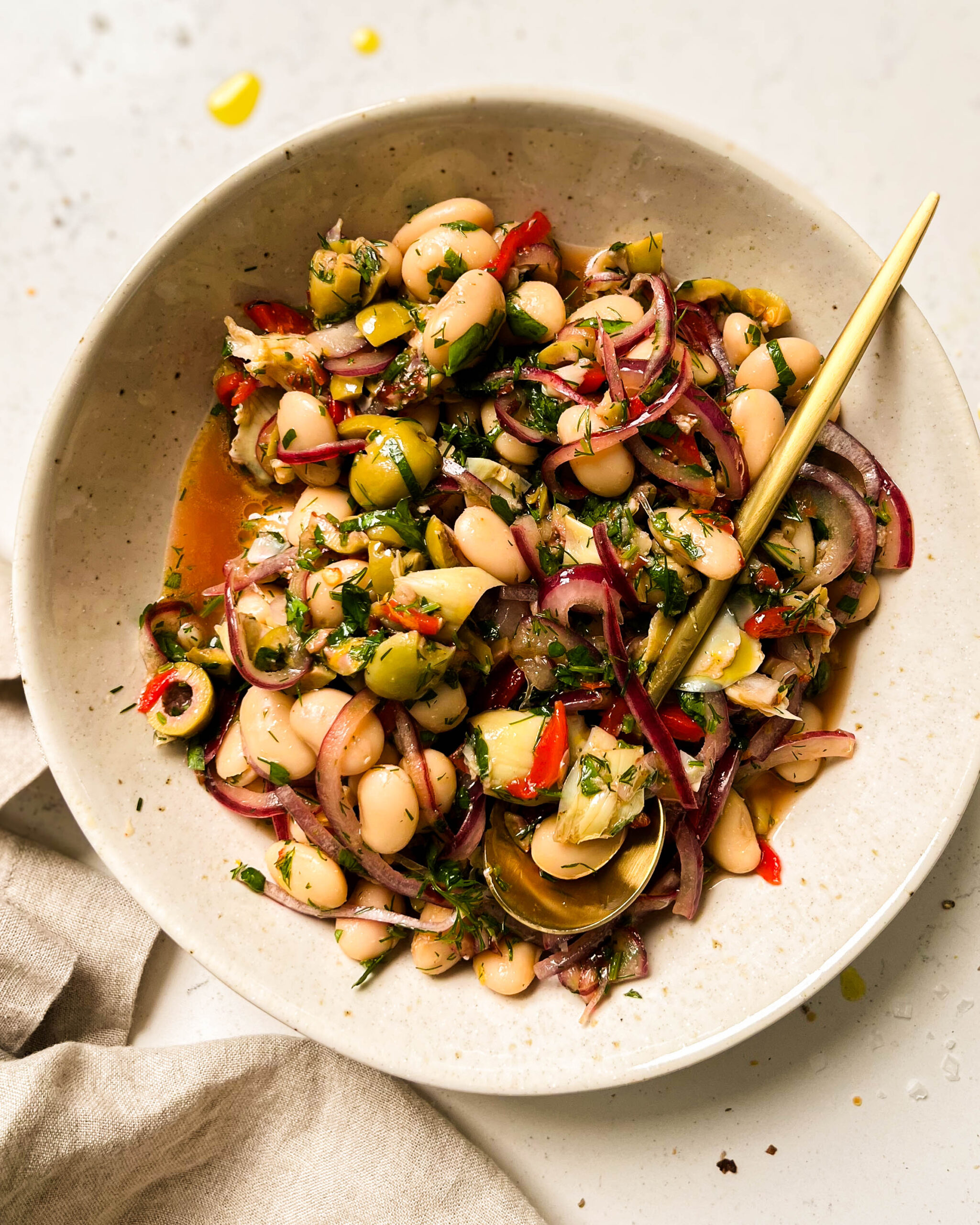 marinated butter beans in a white bowl