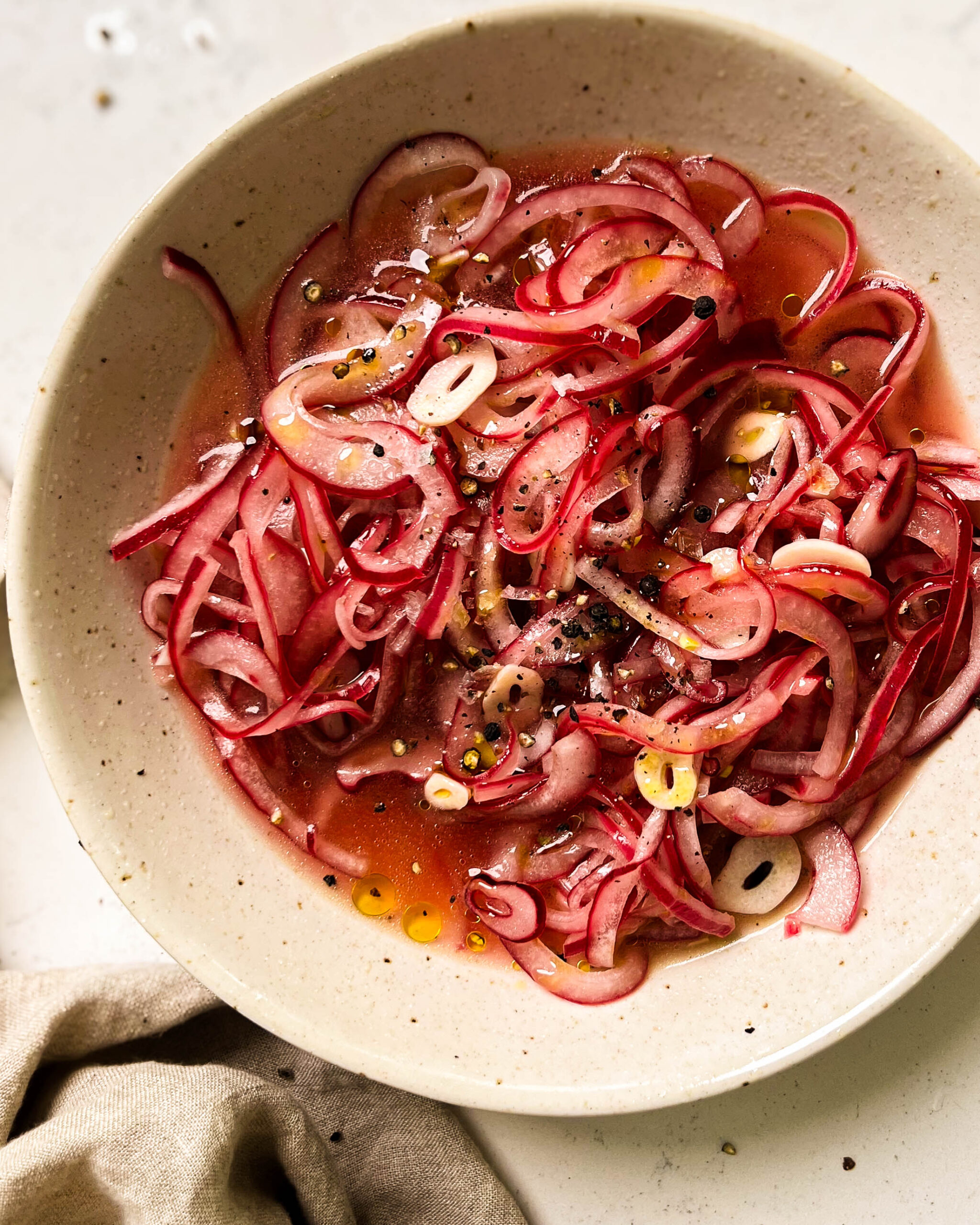 pickled onions in a white bowl