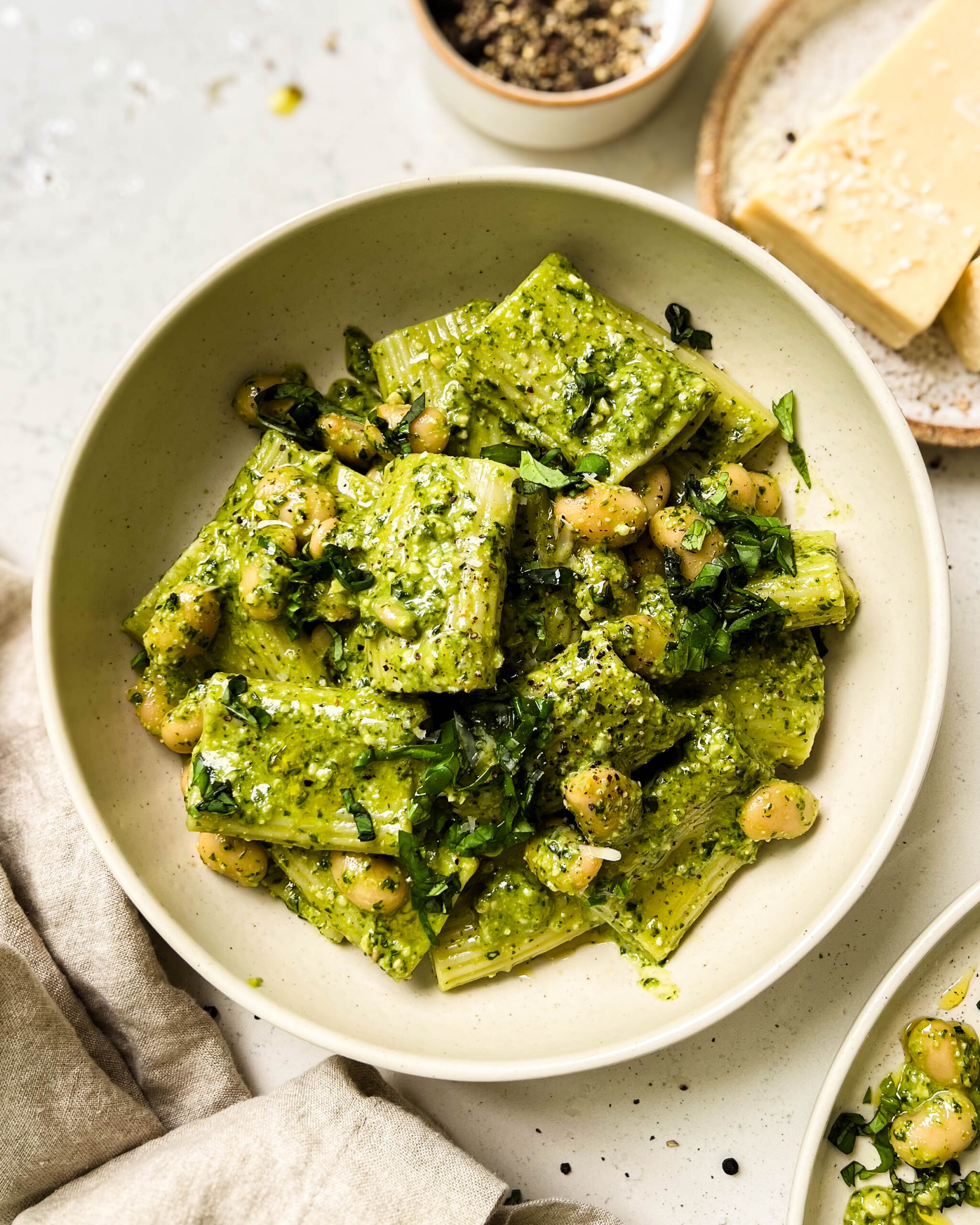 vegan pesto pasta in a beige bowl