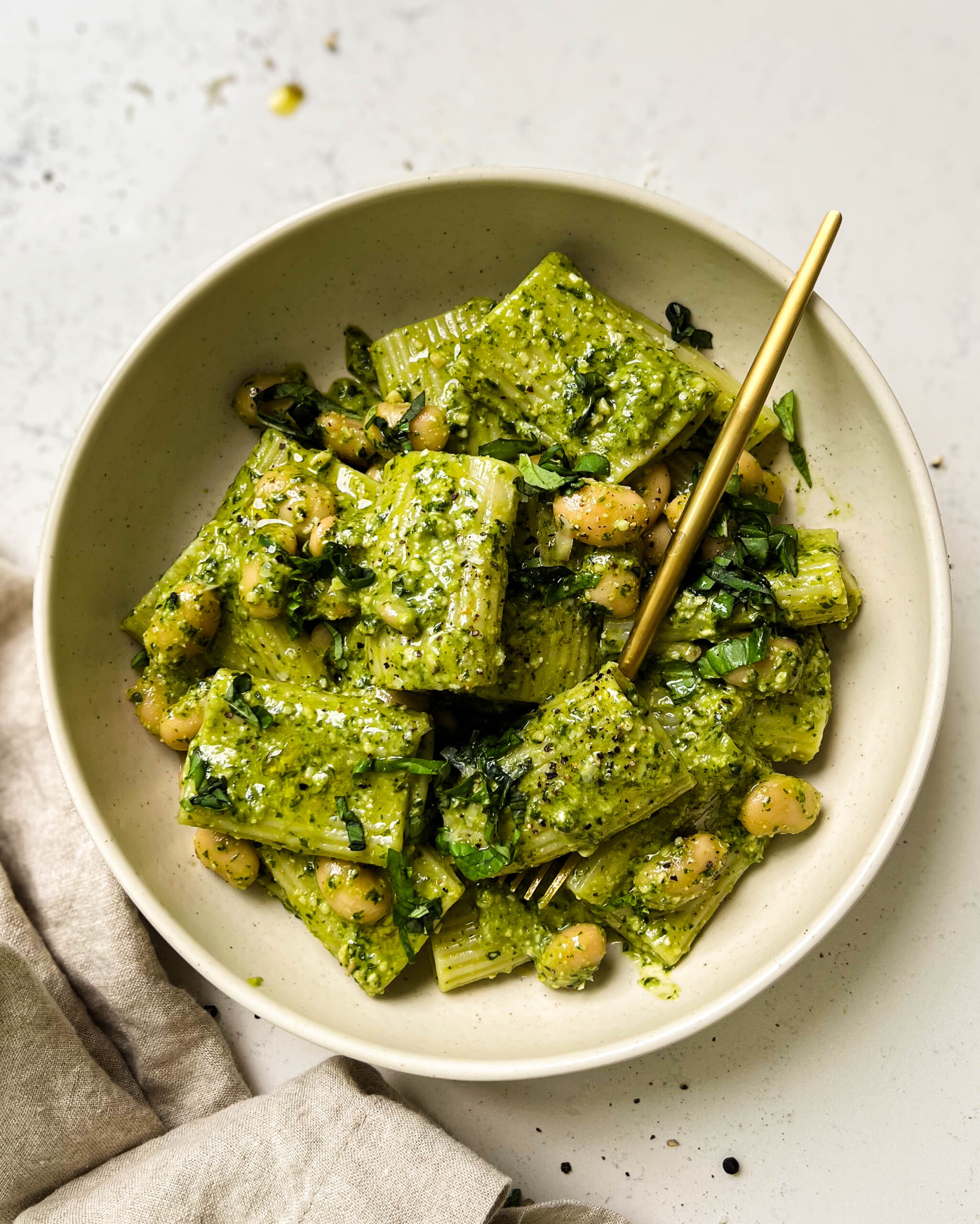 vegan pesto pasta in a beige bowl