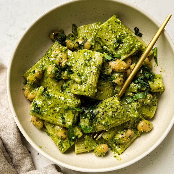 vegan pesto pasta in a beige bowl