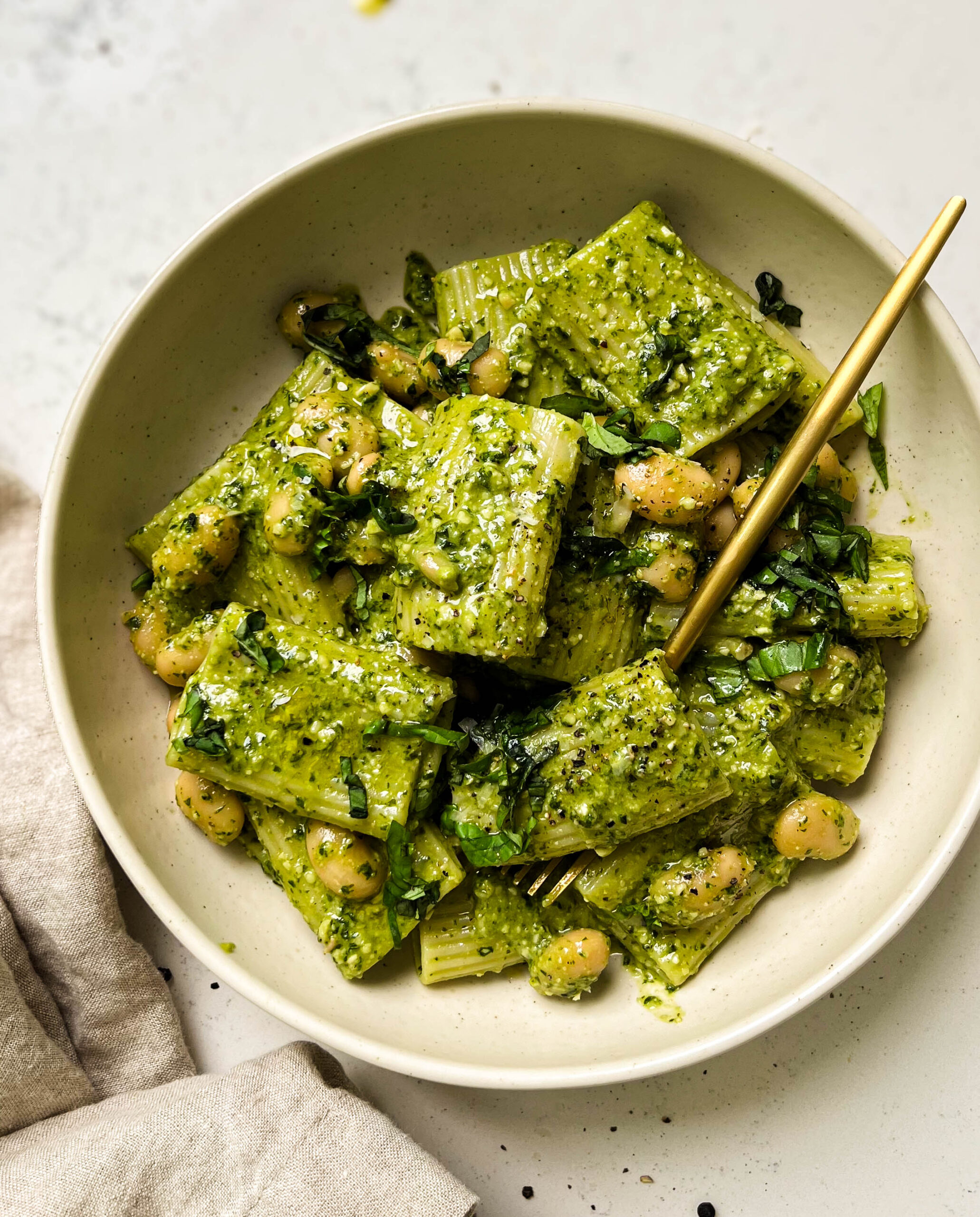 vegan pesto pasta in a beige bowl