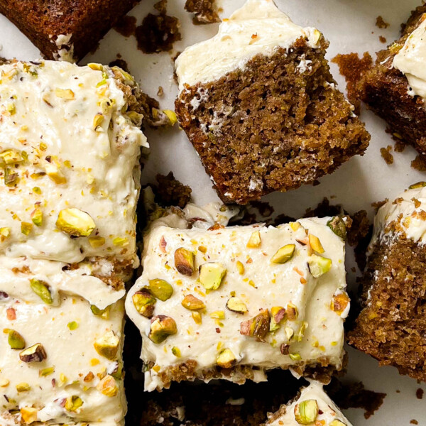 sliced cardamom pistachio cake on parchment paper