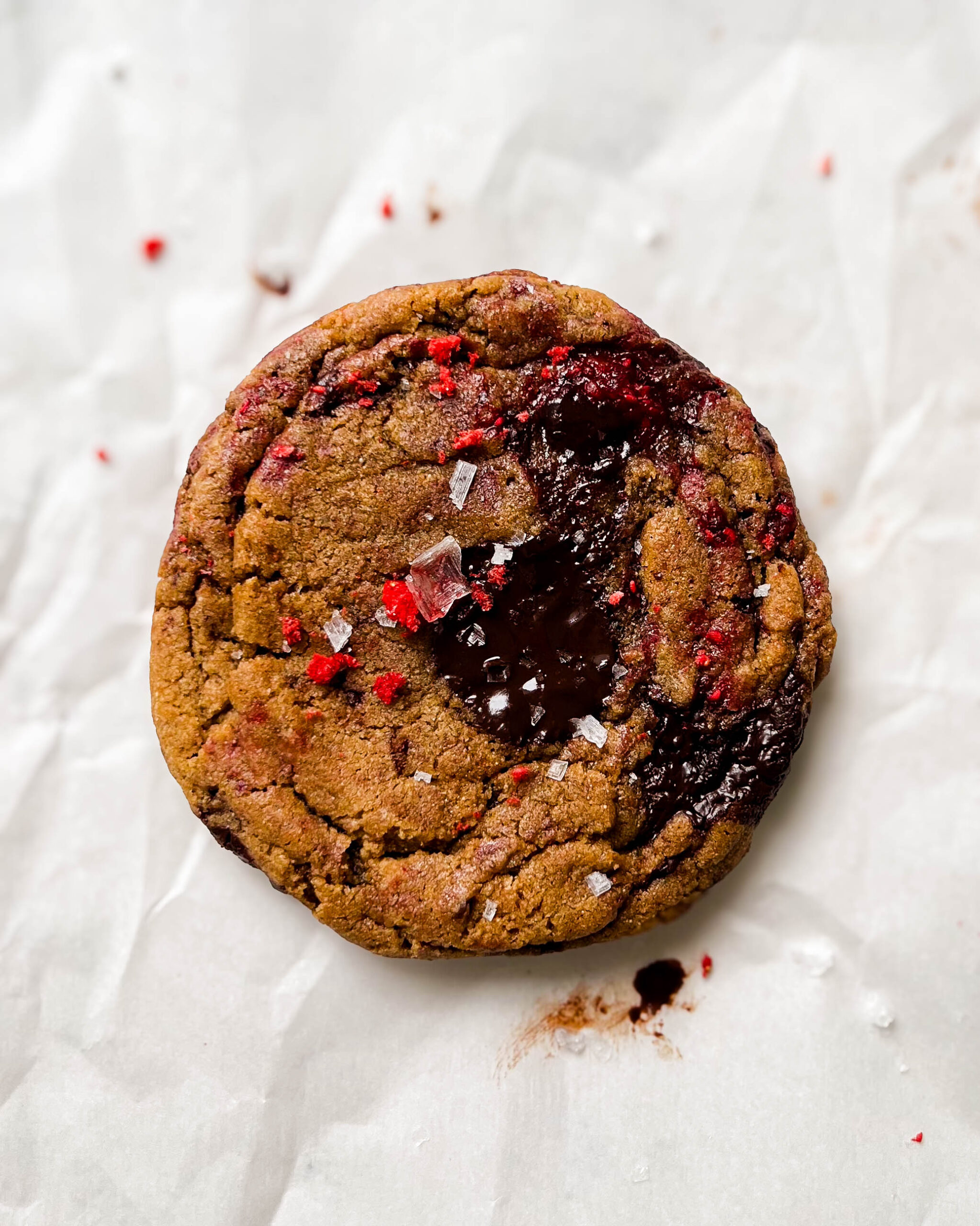 raspberry chocolate chunk cookie on parchment paper