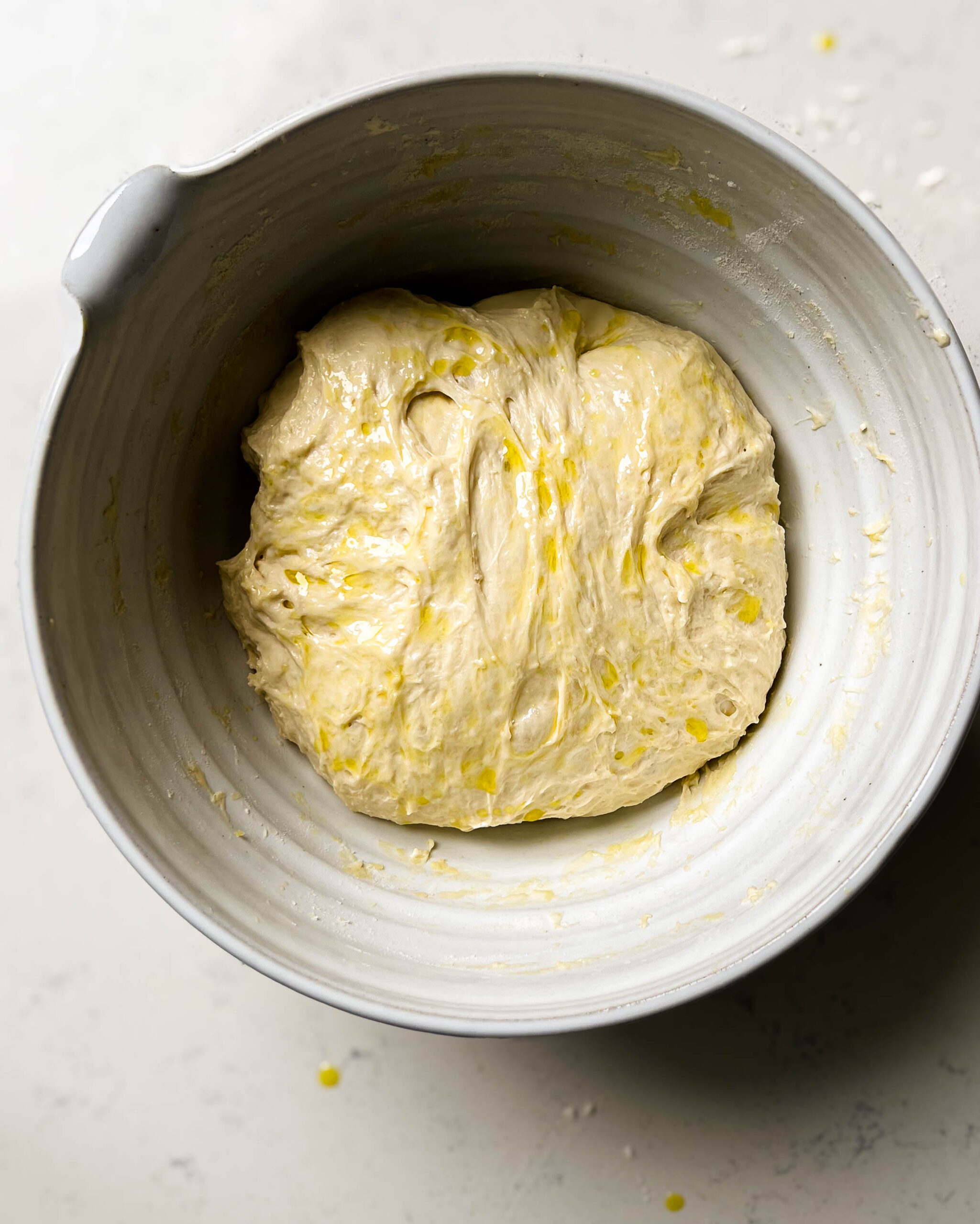 focaccia dough in a ceramic bowl