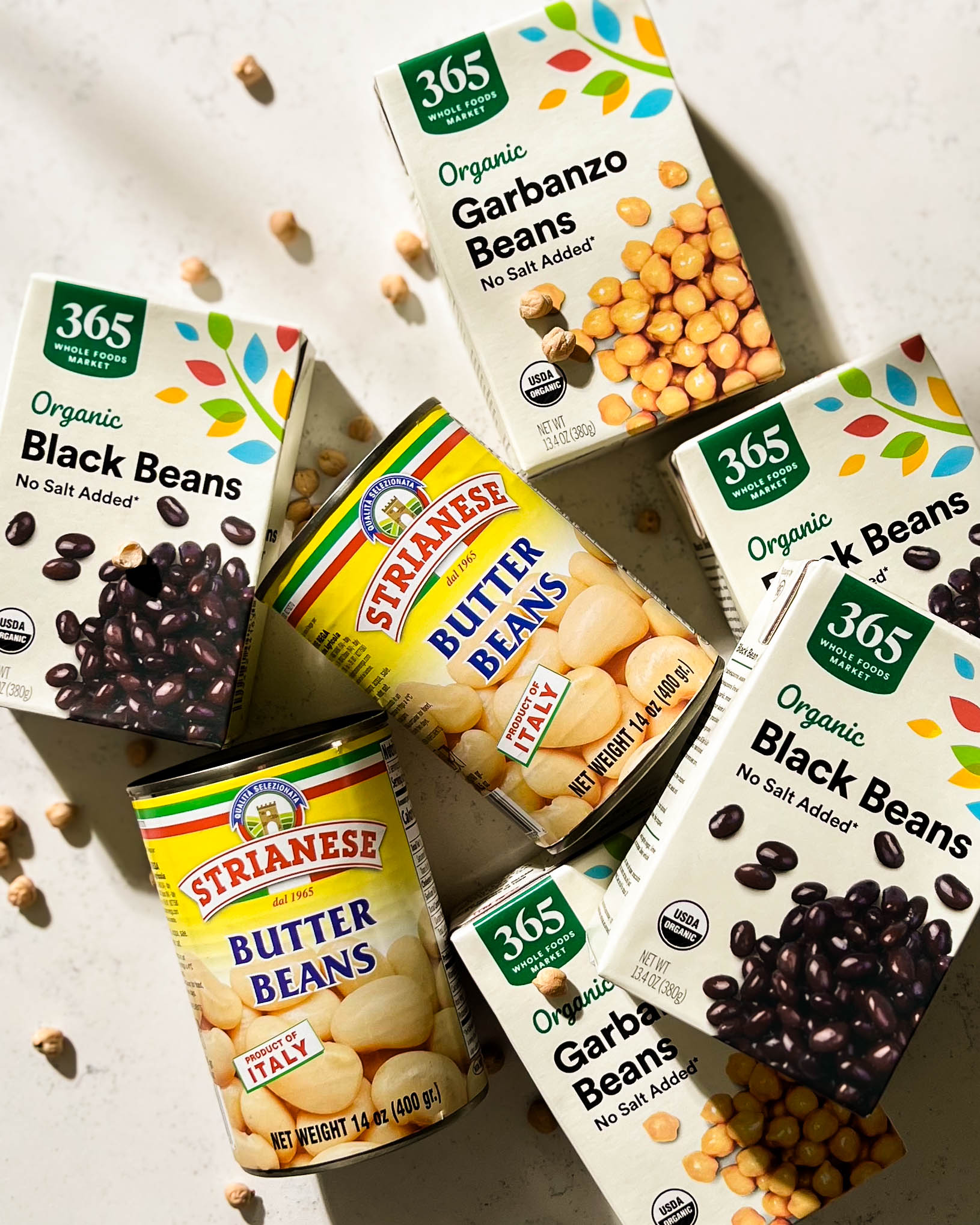 jars and cartons of beans on a white counter