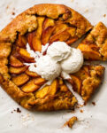 almond peach galette with three scoop of vanilla ice cream on top