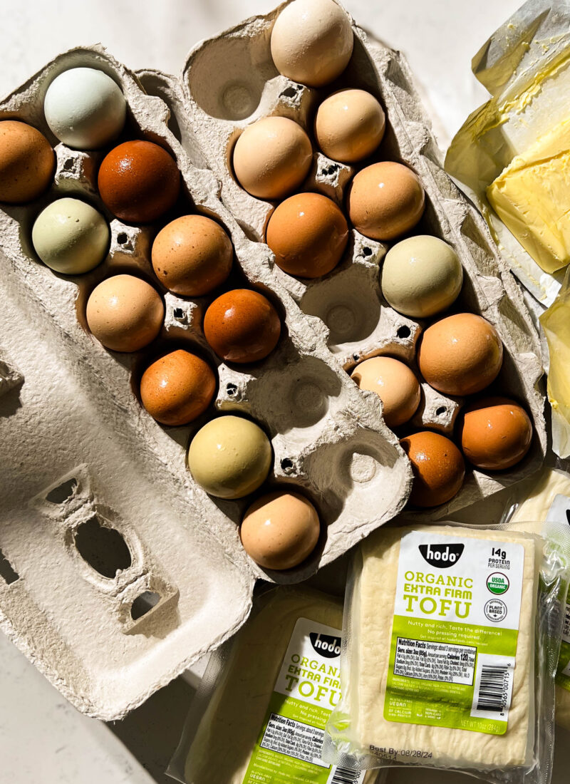 fresh eggs, tofu, and butter on a white counter