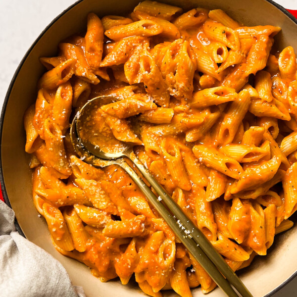 vegan roasted red pepper pasta in a pan with two spoons