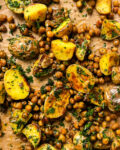 roasted potatoes and chickpeas on a gold pan