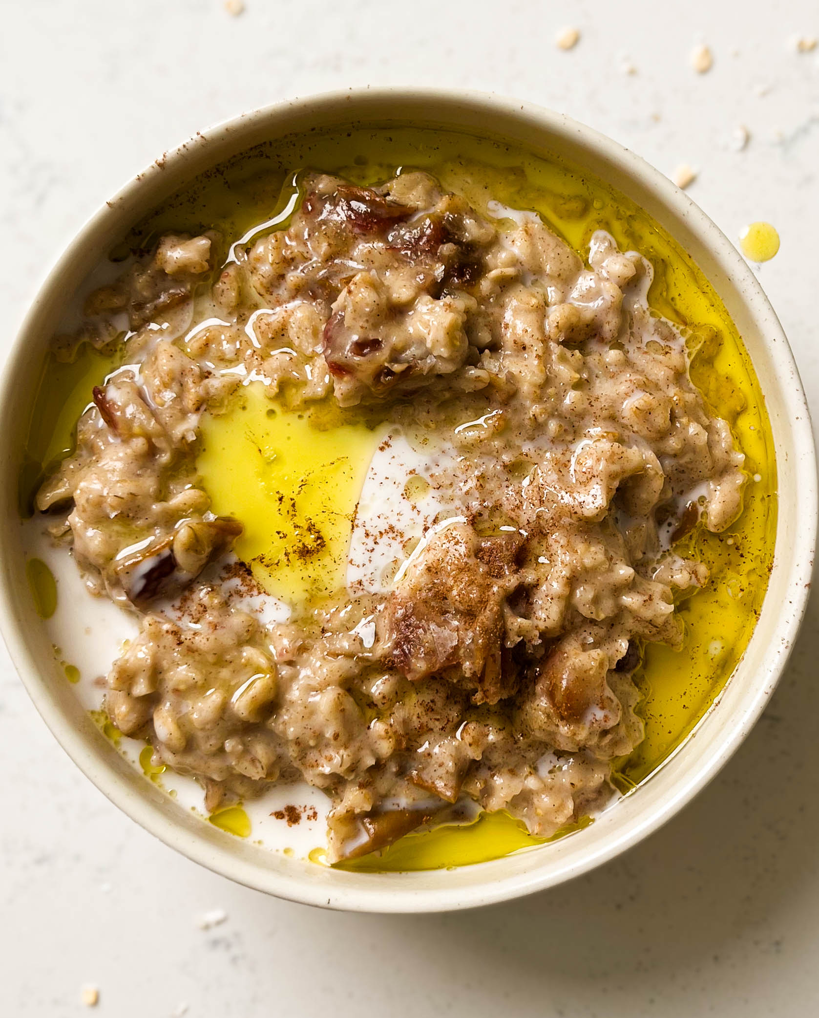 date oatmeal in a bowl with olive oil on top