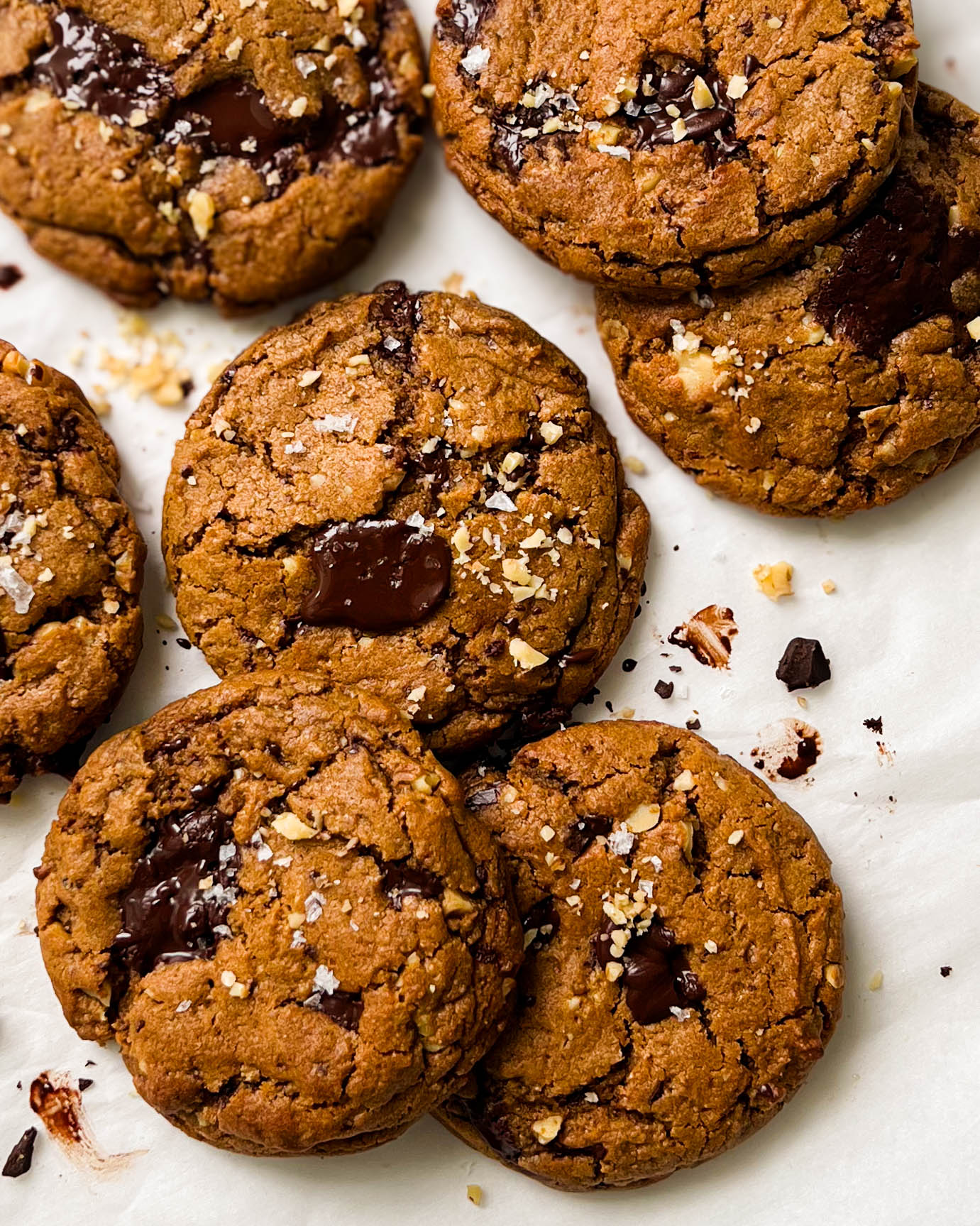 vegan pumpkin spice chocolate chunk cookies on parchment paper