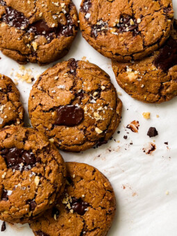 pumpkin spice chocolate chunk cookies on parchment paper