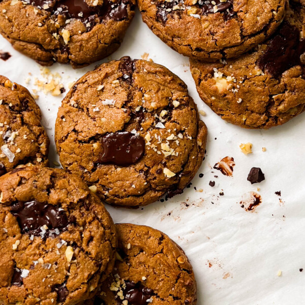 pumpkin spice chocolate chunk cookies on parchment paper