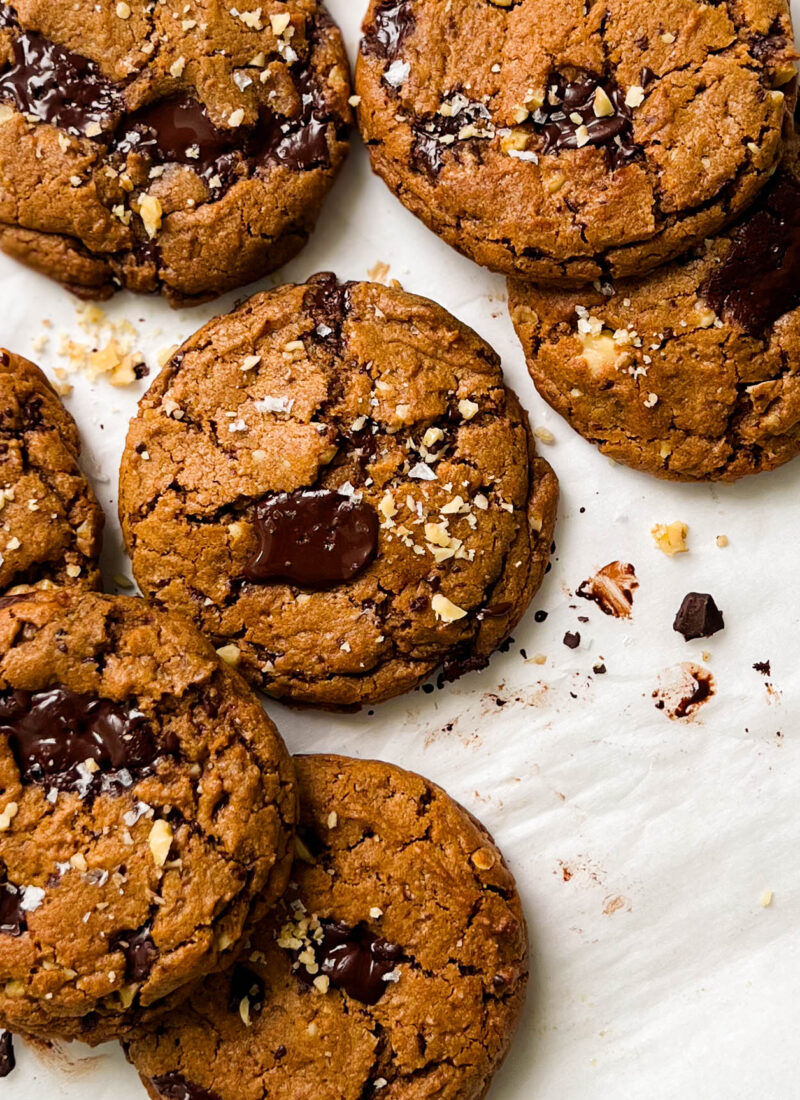 pumpkin spice chocolate chunk cookies on parchment paper