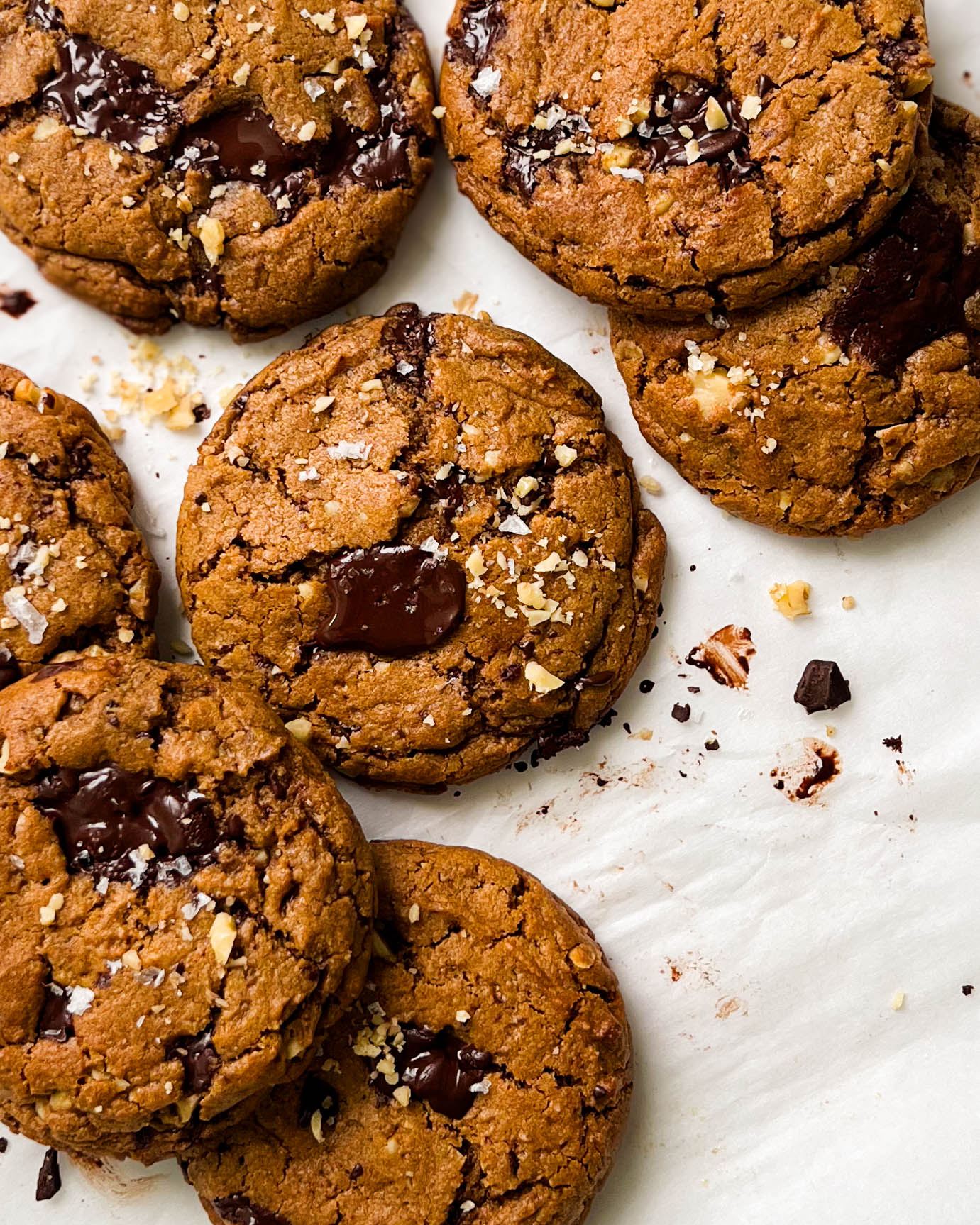 pumpkin spice chocolate chunk cookies on parchment paper