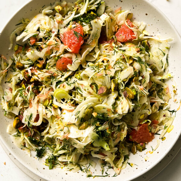 shaved fennel salad in a speckled white bowl