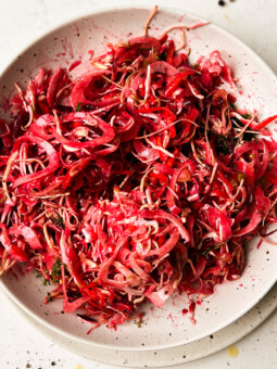 pink slaw salad in a white bowl