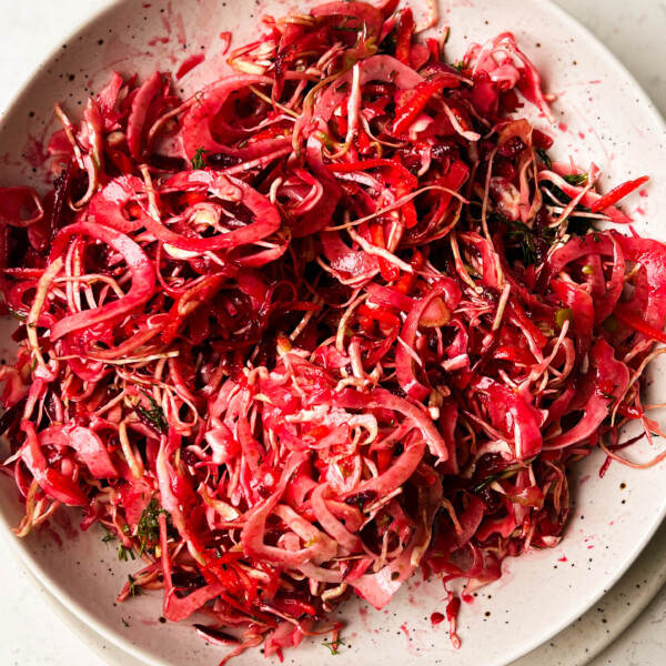 pink slaw salad in a white bowl