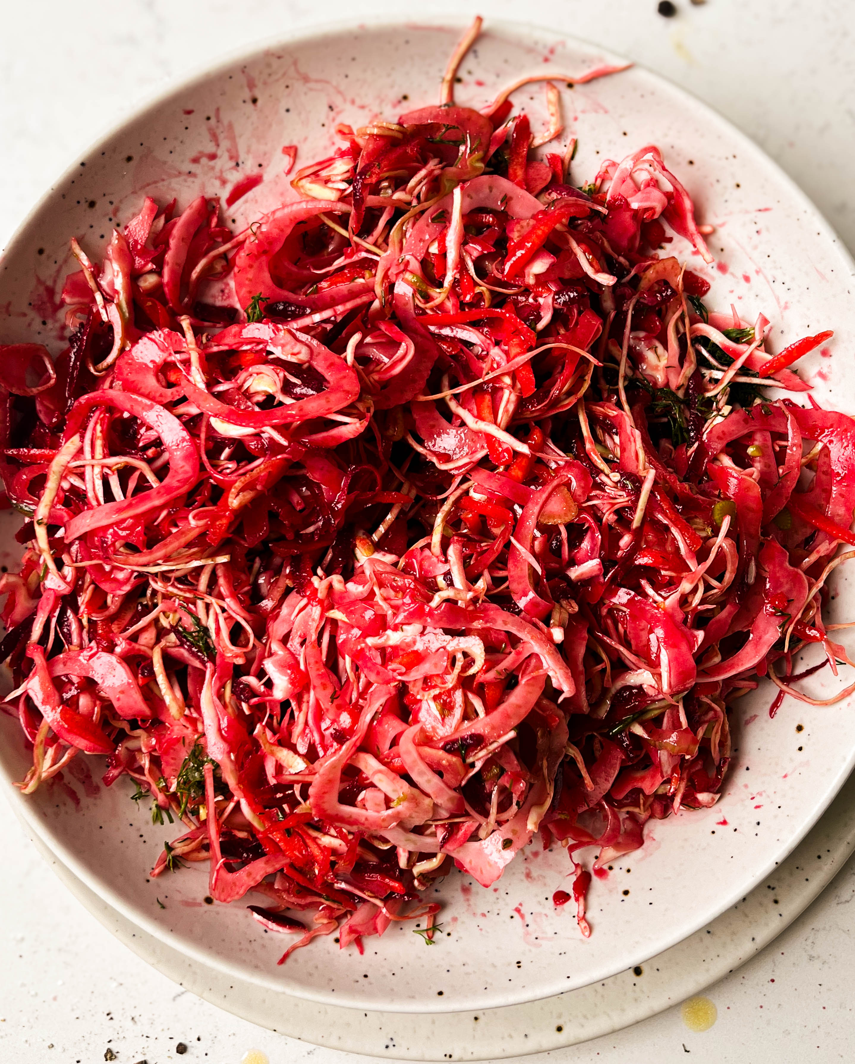 pink slaw salad in a white bowl