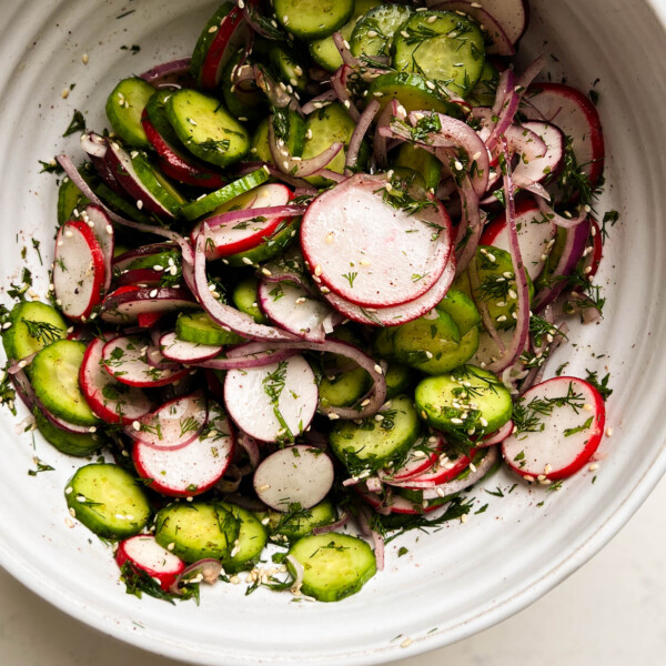 sumac cucumber radish salad in a white bowl