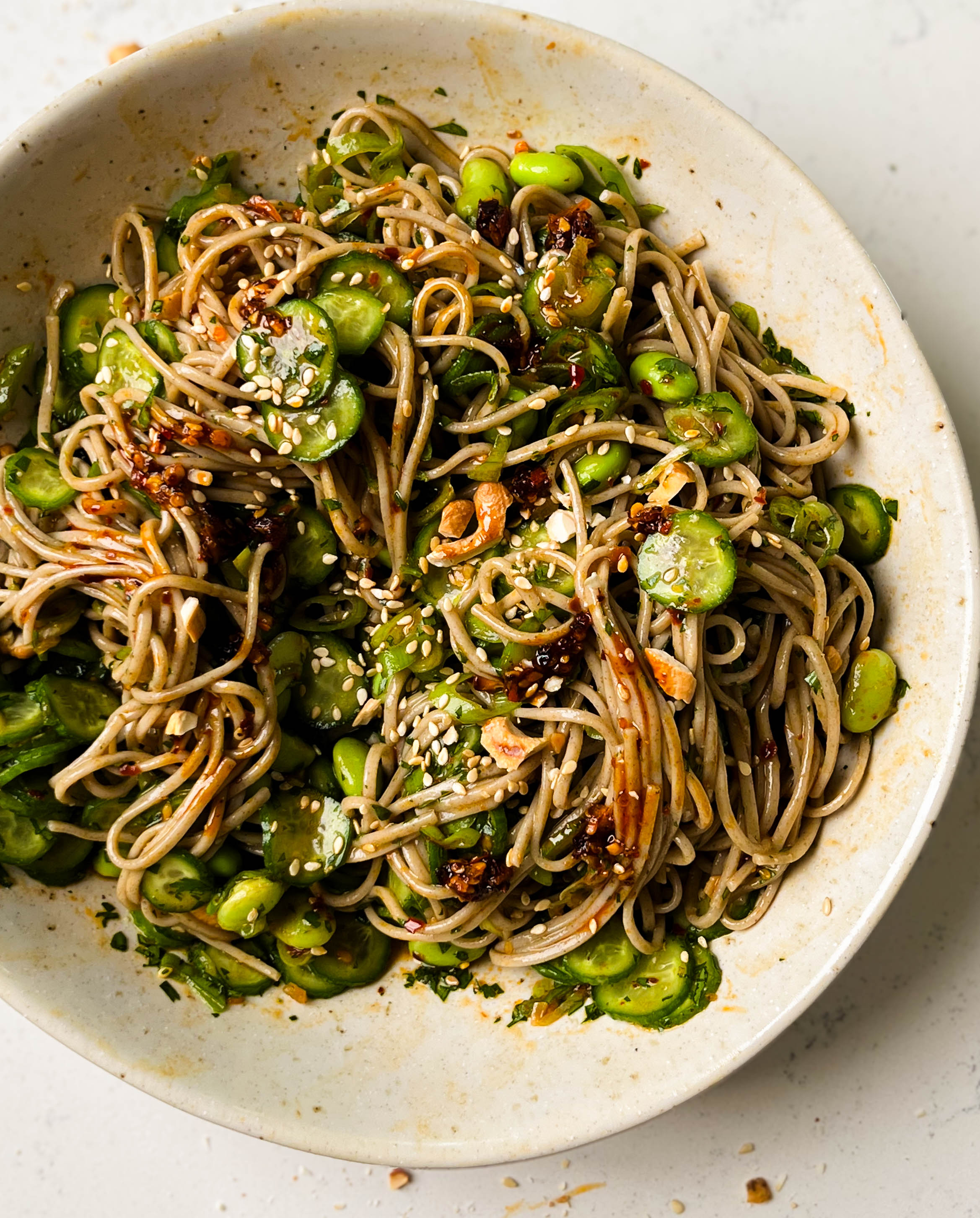 cucumber soba noodle salad in a white bowl