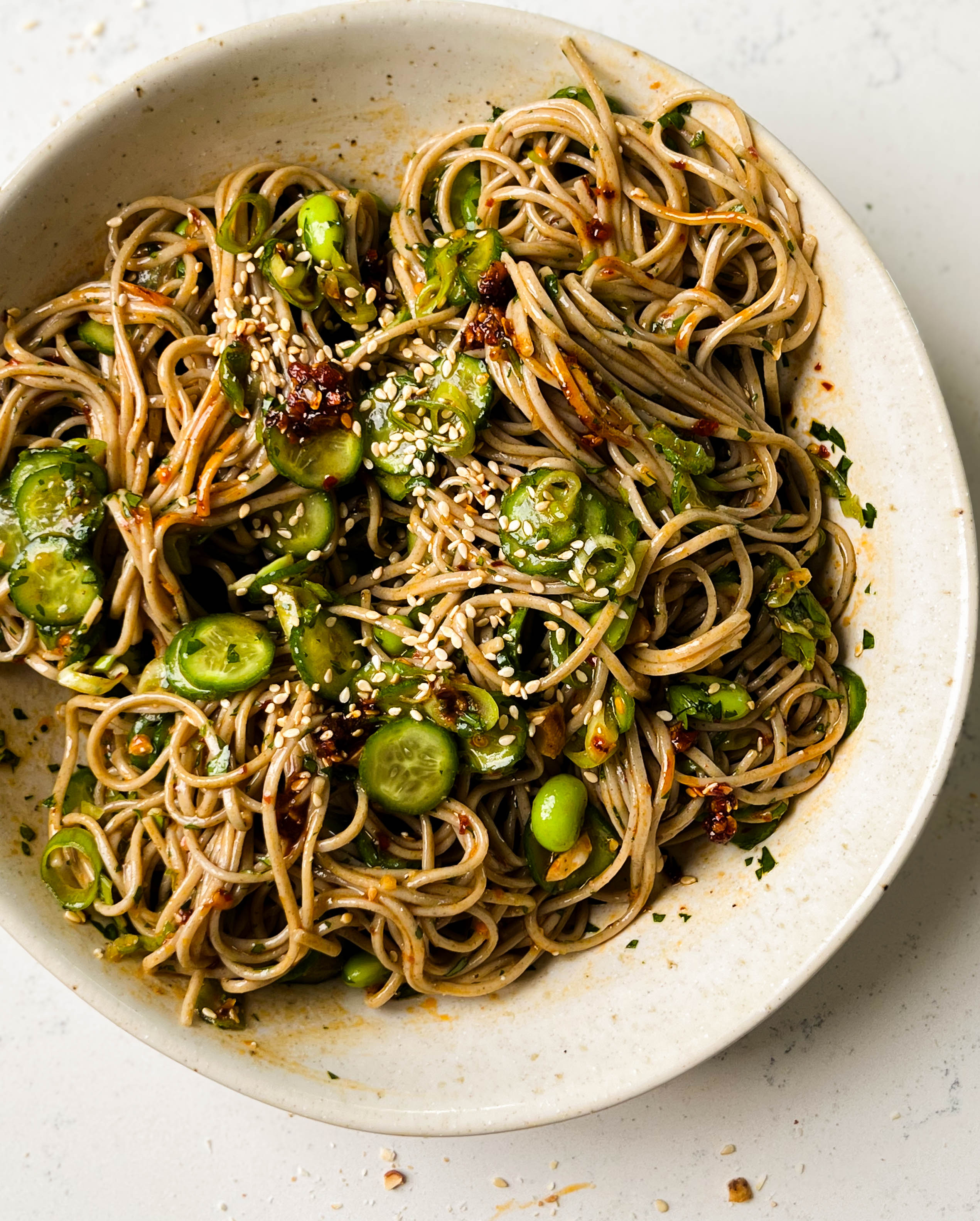 cucumber soba noodle salad in a white bowl