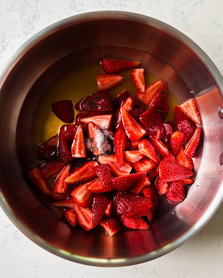 sliced strawberries in a large stainless steel pot